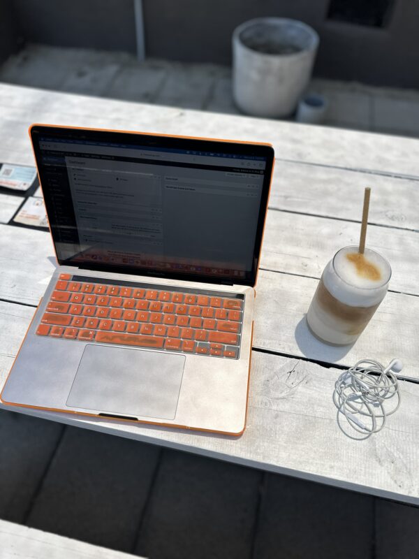 Makeup artist tania russell's laptop computer and an iced latte while working on outreach and emails