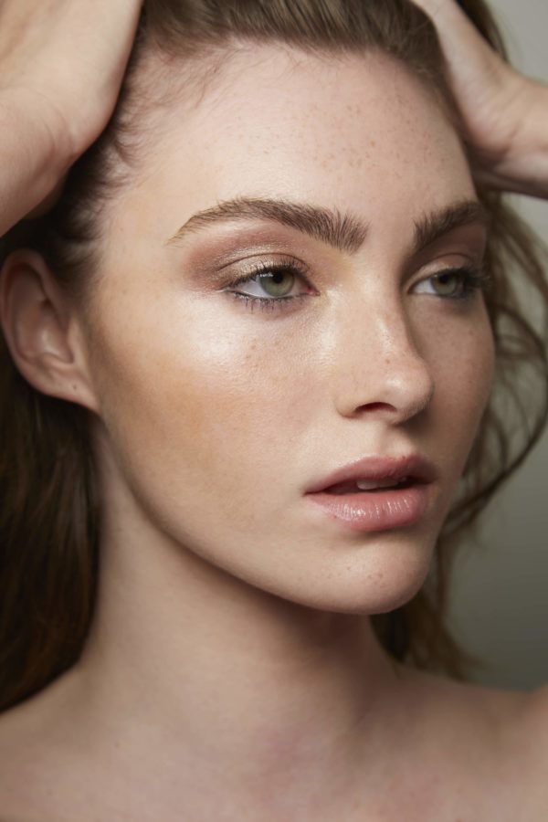 makeup to go blog tania d russell makeup educator Los Angeles San Francisco closeup of white female blue-eyed model with bronze smokey eye and glowy skin