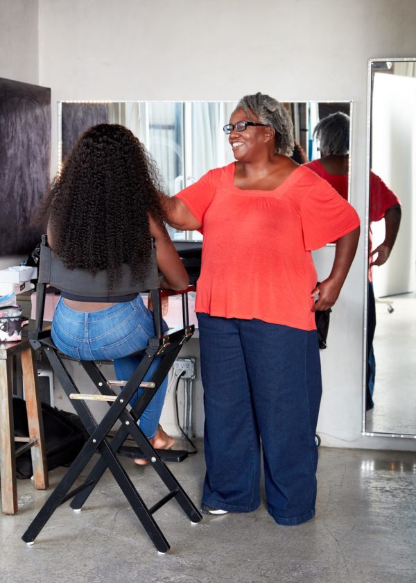 makeup to go blog tania d russell makeup educator Los Angeles San Francisco founder Tania Russell working with a model while wearing a bright orange shirt